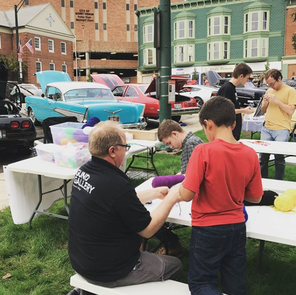 Gund Gallery staff help local children make crafts.